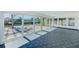 Sun room with tile floors, large windows, and sliders offering scenic outdoor views and natural light at 8722 Elmwood Ln, Tampa, FL 33615