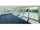 Modern sunroom featuring decorative tile and backyard canal views at 8722 Elmwood Ln, Tampa, FL 33615