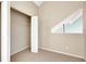 Neutral bedroom with a spacious closet and uniquely shaped window for bright natural light at 12189 Armenia Gables Cir # 12189, Tampa, FL 33612