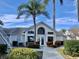 Exterior view of the community clubhouse featuring palm trees and manicured landscaping at 12189 Armenia Gables Cir # 12189, Tampa, FL 33612