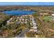 Stunning aerial view of lakefront homes, lush landscaping, and a community baseball field on a sunny day at 1903 Haven Bend, Tampa, FL 33613