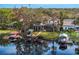 The backyard of this lakefront home features a pool, boat dock, and screened-in lanai at 1903 Haven Bend, Tampa, FL 33613