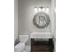 Stylish powder room featuring decorative mirror, modern lighting, and pedestal sink at 1903 Haven Bend, Tampa, FL 33613