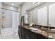 Bathroom features tiled shower with shower curtain and dark brown vanity and countertop at 1903 Haven Bend, Tampa, FL 33613