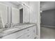 Bathroom features double sinks with granite counters, white cabinets, and views to the bedroom at 1903 Haven Bend, Tampa, FL 33613