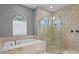Elegant bathroom featuring a soaking tub and frameless glass shower with multiple shower heads at 1903 Haven Bend, Tampa, FL 33613