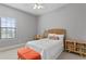 Comfortable bedroom featuring a bed, desk, and natural light from the large window at 1903 Haven Bend, Tampa, FL 33613