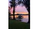 Picturesque view of a boat dock with a sunset backdrop, showcasing tranquility and lakeside charm at 1903 Haven Bend, Tampa, FL 33613