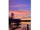 Scenic lakeside view featuring a boat dock, calm waters, and a colorful sky at sunset at 1903 Haven Bend, Tampa, FL 33613