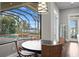 Breakfast nook featuring pool views, and a wrought iron light fixture at 1903 Haven Bend, Tampa, FL 33613