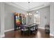 Formal dining room featuring a dark wood table, chandelier lighting, and a decorative window at 1903 Haven Bend, Tampa, FL 33613