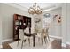Elegant dining room with modern chandelier, table for six, and custom shelving at 1903 Haven Bend, Tampa, FL 33613