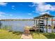 Beautiful lakeside dock with boat house, lift, and sun loungers provides ultimate relaxation and recreation at 1903 Haven Bend, Tampa, FL 33613