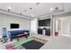 Exercise room with a wet bar, cabinets, mini fridge, workout equipment and a colorful rug at 1903 Haven Bend, Tampa, FL 33613