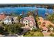 Stunning waterfront home boasts a clay tile roof, circular driveway, and lush landscaping at 1903 Haven Bend, Tampa, FL 33613