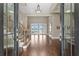 Grand foyer with hardwood floors, staircase, and views through glass doors to the waterfront at 1903 Haven Bend, Tampa, FL 33613