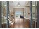 Inviting foyer with hardwood floors, staircase, and water views through the glass doors at 1903 Haven Bend, Tampa, FL 33613