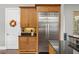 Kitchen featuring stainless steel refrigerator, granite counters and custom cabinets at 1903 Haven Bend, Tampa, FL 33613