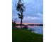 Peaceful lake scene featuring a boat dock, calm waters, and a serene sky, creating a tranquil atmosphere at 1903 Haven Bend, Tampa, FL 33613