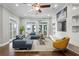 Spacious living room with hardwood floors, large windows providing lake views, and comfortable seating arrangements at 1903 Haven Bend, Tampa, FL 33613