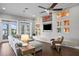 Spacious living room featuring hardwood floors, recessed lighting, and views of the outdoor patio and lake at 1903 Haven Bend, Tampa, FL 33613