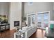 Bright living room boasts a fireplace, hardwood floors, and french doors with water views at 1903 Haven Bend, Tampa, FL 33613