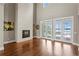 Bright living room features hardwood floors, fireplace, and French doors that lead to a view at 1903 Haven Bend, Tampa, FL 33613