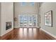 Spacious living room with a fireplace, tall ceilings, and french doors to a pool with water views at 1903 Haven Bend, Tampa, FL 33613