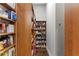 Walk-in pantry with custom wood shelving for organized storage at 1903 Haven Bend, Tampa, FL 33613