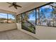 Screened patio features tile flooring, a ceiling fan, and views of the surrounding lake and neighborhood at 1903 Haven Bend, Tampa, FL 33613