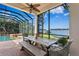 Beautiful covered patio with lake views, outdoor seating, and access to a pool and hot tub at 1903 Haven Bend, Tampa, FL 33613