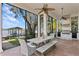 Screened patio offers outdoor dining with lake views, built-in grill and ample space for entertaining at 1903 Haven Bend, Tampa, FL 33613