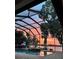 A pool is enclosed by a beautiful sunset view and trees at 1903 Haven Bend, Tampa, FL 33613