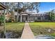 Lakeside home with covered patio and private dock offers a serene and luxurious retreat at 1903 Haven Bend, Tampa, FL 33613