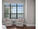 Bright sitting area with two chairs, a table, and a large window with serene outdoor views at 1903 Haven Bend, Tampa, FL 33613