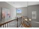 Elegant staircase with wooden railings, a statement chandelier, and arched window with natural light at 1903 Haven Bend, Tampa, FL 33613