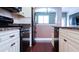 Kitchen with black stainless-steel appliances and off-white cabinetry at 200 4Th S Ave # 139, St Petersburg, FL 33701