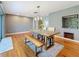 Bright dining room with exposed brick, hardwood floors, and natural light at 2446 Belleair Rd, Clearwater, FL 33764