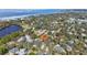 An aerial view of a neighborhood showcasing its proximity to the water and lush surroundings at 363 Sanctuary Dr, Crystal Beach, FL 34681
