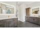Bathroom featuring double vanities, wood cabinets, tile flooring, and back-lit mirrors at 363 Sanctuary Dr, Crystal Beach, FL 34681