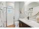 Modern bathroom with stylish vanity, round mirror, walk-in shower, and beach themed artwork at 363 Sanctuary Dr, Crystal Beach, FL 34681