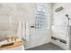 Contemporary shower features a glass block window, rain shower head, and sleek tile work at 363 Sanctuary Dr, Crystal Beach, FL 34681