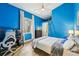 Cozy blue bedroom with a desk and chair, ideal for work or relaxation at 363 Sanctuary Dr, Crystal Beach, FL 34681