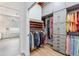 Organized walk-in closet featuring custom shelving, drawers, and ample storage space with adjoining bathroom at 363 Sanctuary Dr, Crystal Beach, FL 34681