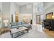 Sun-drenched living room with high ceilings, a comfortable sofa, and an adjacent dining area at 363 Sanctuary Dr, Crystal Beach, FL 34681