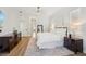 Spacious bedroom features white bedding, wood floors, and dark wood furnishings creating a comfortable ambiance at 363 Sanctuary Dr, Crystal Beach, FL 34681