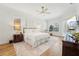 Airy bedroom with white linens, natural light, and a view of the pool creates a relaxing retreat at 363 Sanctuary Dr, Crystal Beach, FL 34681