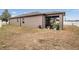 Exterior view of the home and backyard, featuring the screened in lanai at 714 Sugar Camp Way, Brooksville, FL 34604