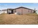 View of the home's backyard and exterior, featuring an air conditioning unit at 714 Sugar Camp Way, Brooksville, FL 34604