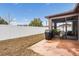 View of the home's backyard featuring a screened in lanai and privacy fence at 714 Sugar Camp Way, Brooksville, FL 34604